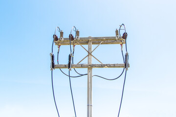 Closeup of concrete pole electric with power cable on pole Blue sky on background