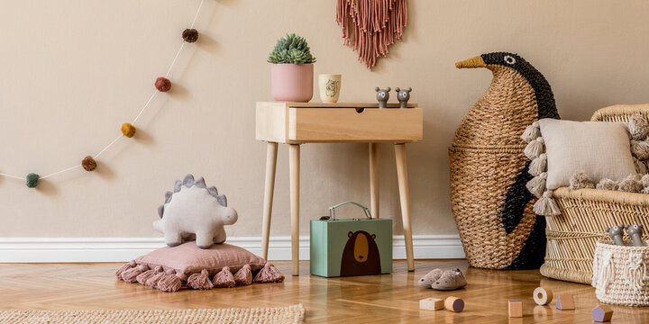 Stylish scandinavian interior of child room with natural toys, hanging decoration, design furniture, plush animals, teddy bears and accessories. Beige walls. Interior design of kid room. Template.