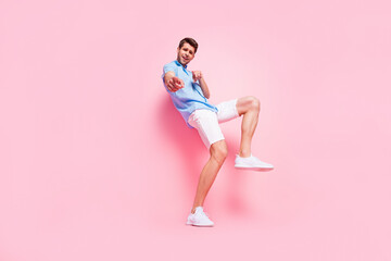 Fototapeta na wymiar Photo of imposing crazy guy direct finger choose you wear blue shirt shorts shoes isolated on pink color background