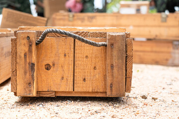 A supply wooden crate box placed on ground. It's using to contain military items such as weapon and...