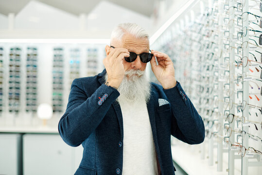 Aged man in stylish sunglasses in optical store