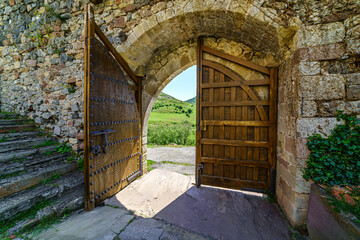 Main entrance door to the castle made of old wood. Argueso Santander.