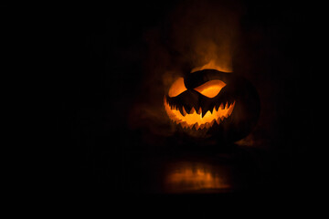 Halloween pumpkin smile and scary eyes for party night. Close up view of scary Halloween pumpkin...