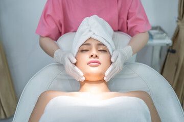 Woman doing facial massage. Women are getting beauty by injecting fillers on their faces.