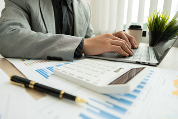 Businessman working in finance and accounting Analyze financial budget in the office.