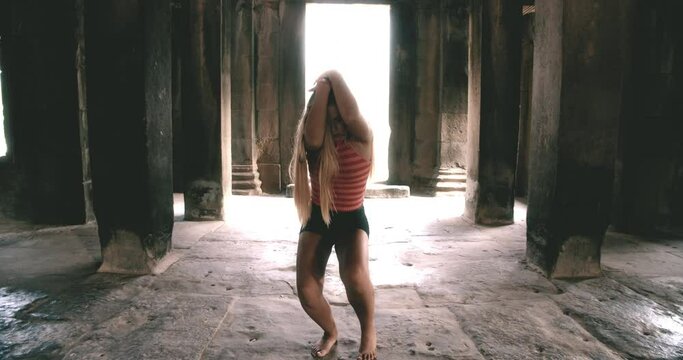 A Female Dancer Dances Passionately Inside a Cambodian Temple
