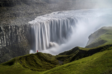 Fototapeta premium Person Staring over Dettifoss Waterfall, Vatnajökull National Park, Iceland