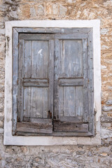 Old double closed wooden shutters. Vertical view.