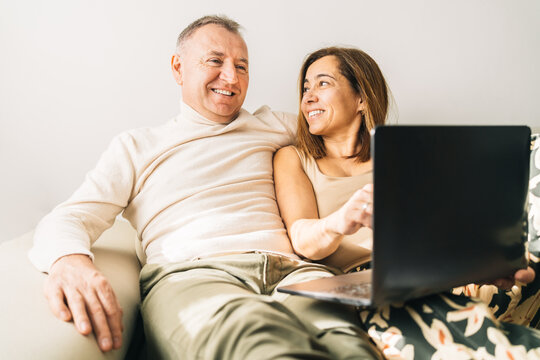 Content couple watching movie on laptop at home