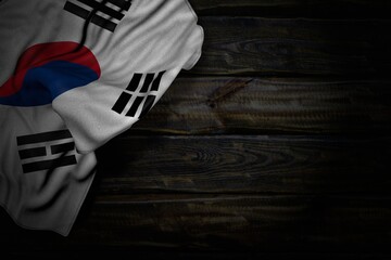 wonderful dark photo of Republic of Korea (South Korea) flag with large folds on old wood with empty place for text - any celebration flag 3d illustration..