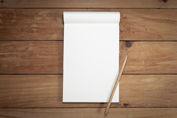 blank note with pencil on wooden background. 