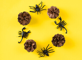 A round frame of cones and figures of spiders and scorpions on a yellow background. Halloween...