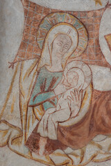 Ancient wall-painting of Virgin Mary and the child on her laps in the stable