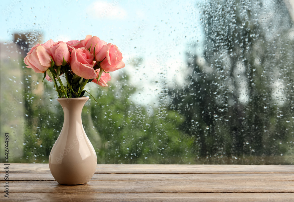 Poster Vase with roses near window on rainy day. Space for text