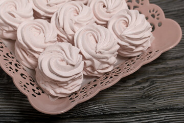Marshmallow on a plate. Stands on brushed pine boards.