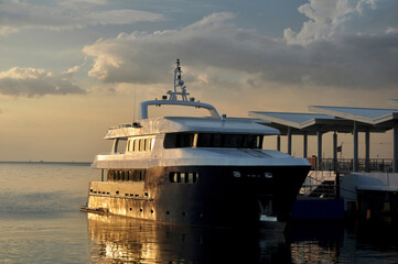 Maynila Yacht Club and ferry service terminal for filipino people and foreign travelers passenger journey visit use service travel visit at Roxas Boulevard road sunset dusk time in Manila, Philippines