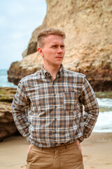 Portrait of a young man on the beach of Shark Fin Bay on the California coast. Beautiful panoramic landscape