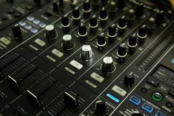 Fototapeta na wymiar Wide angle photo of black sound mixer controller with knobs and sliders