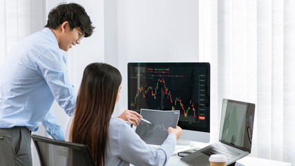 Financial concept a couple of stock traders thinking of strategy of investment to gain the highest profit.