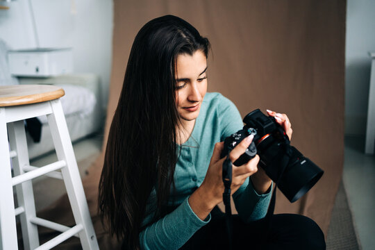 Photographer with photo camera on creased fabric