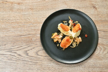 boiled salty egg half cut with slice ginger salad on plate