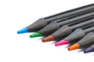 Colored pencils lying diagonally on white background.