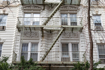 Fire Escape on a Beautiful Old White Residential Building in New York City - obrazy, fototapety, plakaty