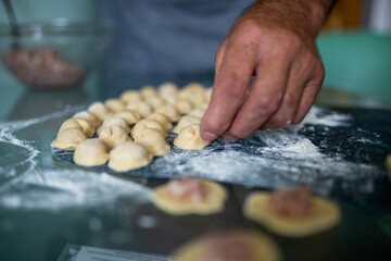 women's hands sculpt homemade dumplings close up