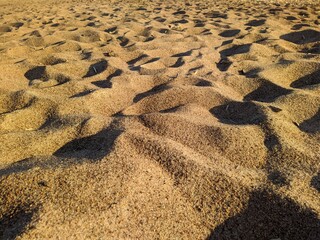 sand on the beach during the daytime in summer.