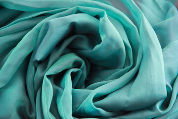 the texture of turquoise fabric with pleats
