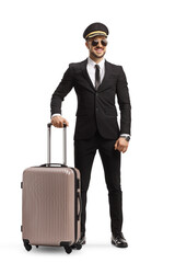 Full length portrait of a man in a suit and tie with sunglasses and a cap carrying a suitcase