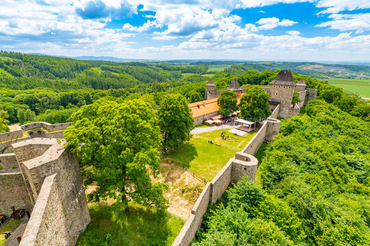 Medieval castle Helfstyn, Czech Republic. Ancient castle in gothic style. Castle walls and interiors, beautiful old tower. Summer weather, blue sky with clouds. Famous trip destination.