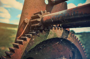 Rusty old big gears are covered with cobwebs