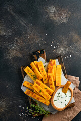 Homemade polenta chips fries with sea salt, parmesan, thyme, rosemary with yogurt sauce. Typical...