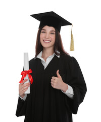 Happy student in academic dress with diploma showing thumb up on white background