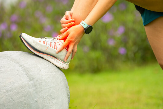 Sport woman has sore ankle from exercising training. It is a common injury for runners. Ankle pain, painful point.