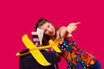 A pretty girl with passport and coronavirus test packed her suitcase for travel in corona virus epidemic time.