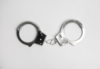 Classic chain handcuffs on white background, top view