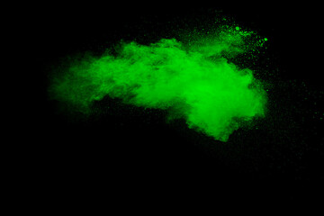 Green powder explosion on black background.