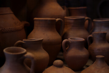 textured clay jugs laid out in a row