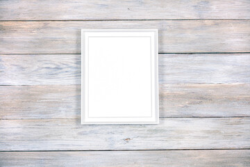 White frame mockup on a plank table