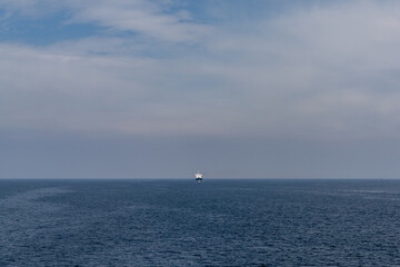large freight ship travelling full steam ahead and approaching from far away on the open ocean