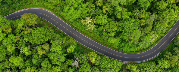 Winding road in the forest The top view of the beautiful Aerial view of asphalt road, the highway...