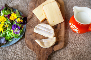 Cheese, flower salad and red pitcher.