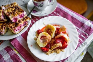 Strawberry dumpling, cherry cake and coffee on table.