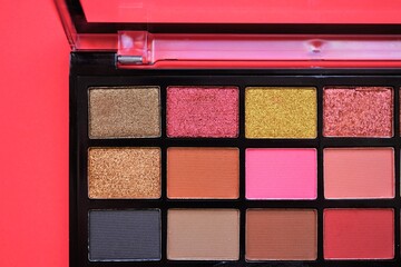 Set of eyeshadows in a black box on the red table