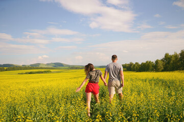 couple walking in blossom field