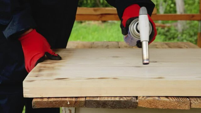 Firing wood with a gas burner for finishing. Firing technology, close-up, industrial