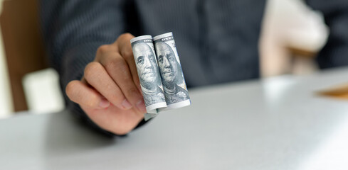 Businessman hand displaying a spread of cash