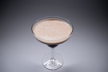 luxury espresso martini cocktail drink in elegant glass on grey background